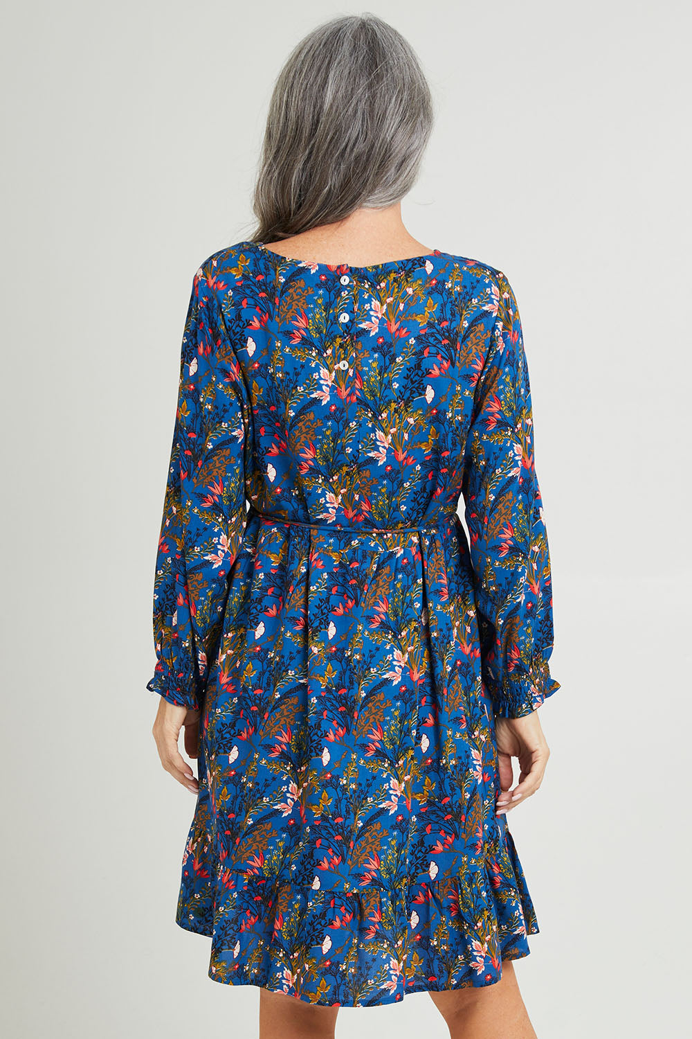 Model Luisa wearing size S of the Rome Dress in colour Corsica (Blue), from the back