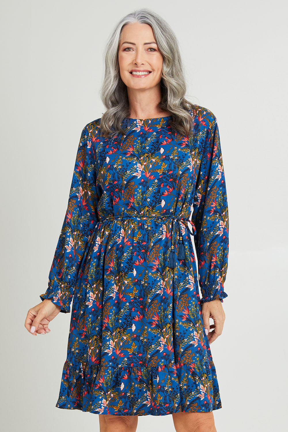 Model Luisa wearing size S of the Rome Dress in colour Corsica (Blue), from the front, cropped image