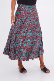Model Alex wearing the Gigi Maxi Skirt in colour Miamiprint (Green), from the front, cropped image