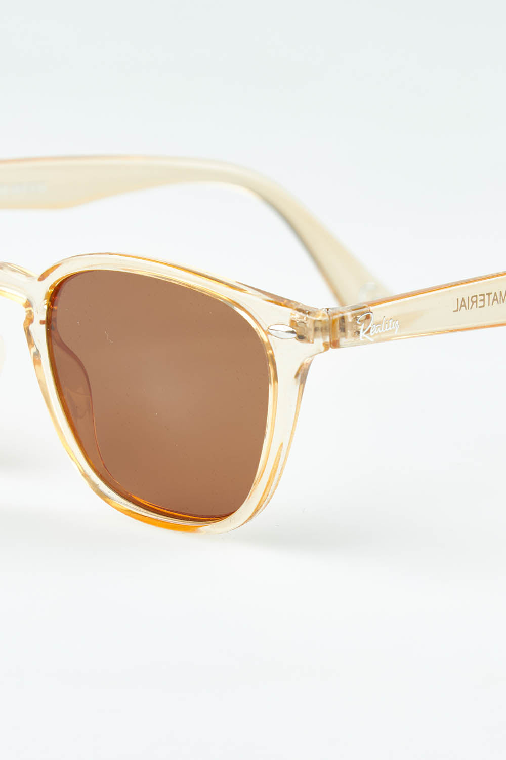 A model wearing The Chelsea Square Sunglasses in colour Prosecco, from the front, showing the whole outfit