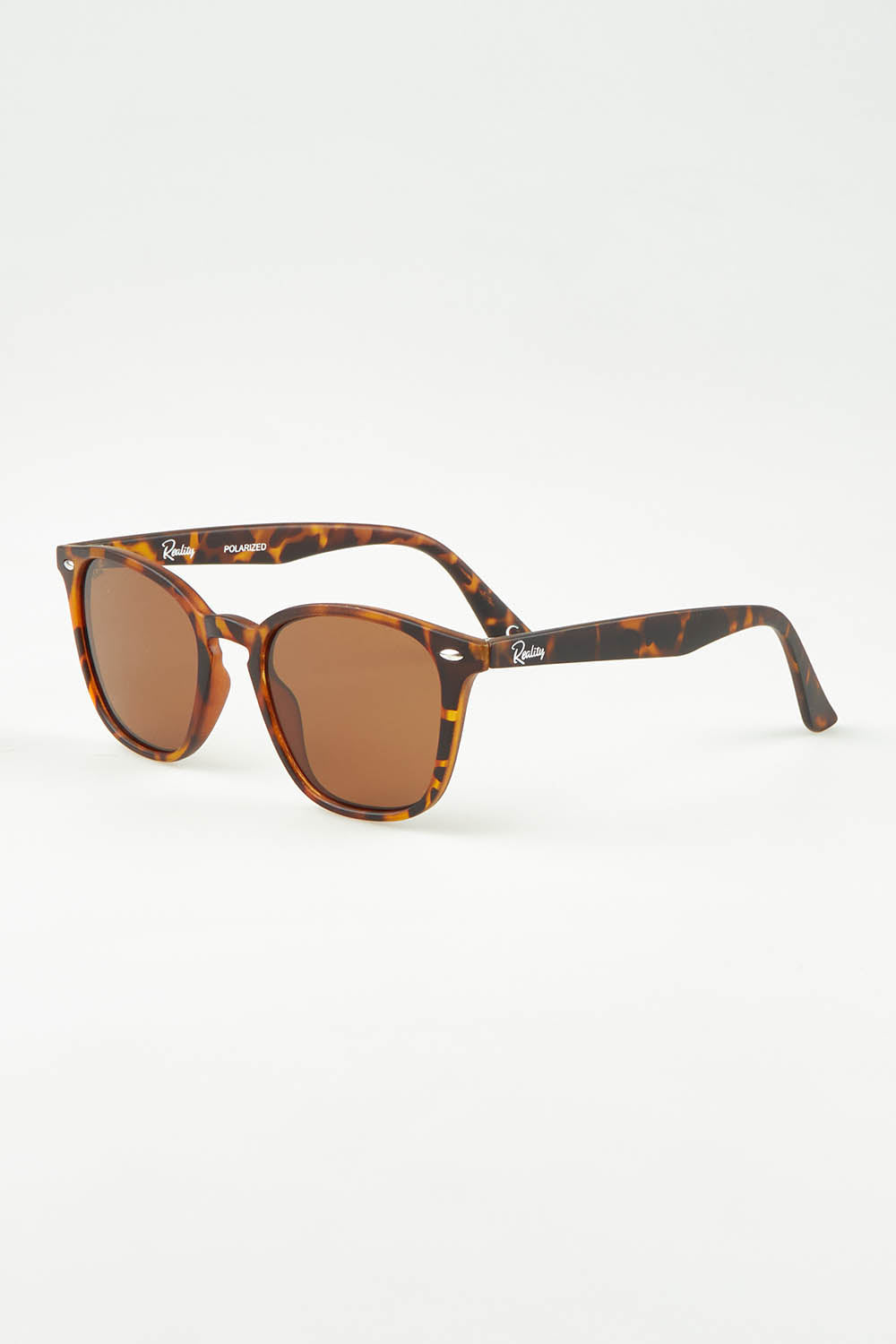 A model wearing size OneSize of The Chelsea Square Sunglasses in colour Tortoise, from the front, showing the whole outfit