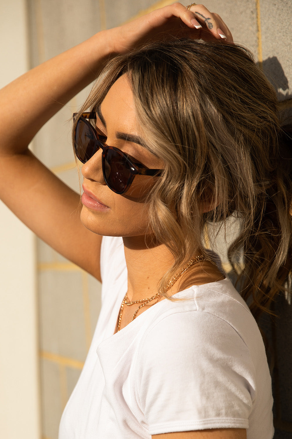 A model wearing The Chelsea Square Sunglasses in colour Tortoise, from the front, cropped image