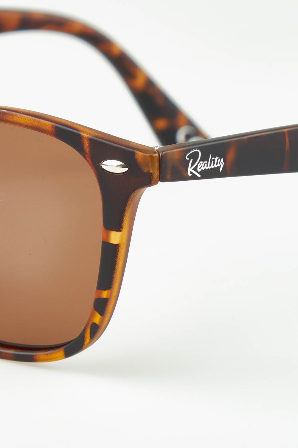 A model wearing The Chelsea Square Sunglasses in colour Tortoise, from the front, showing the whole outfit