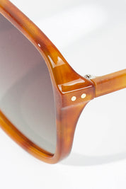 A model wearing size OneSize of the Della Spiga Sunglasses in colour Vintage, from the front, showing the whole outfit