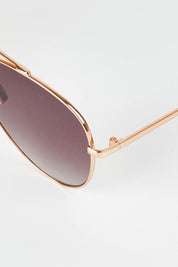 A model wearing size OneSize of the Mr Chips Sunglasses in colour RoseGold (Metallics), from the front, showing the whole outfit
