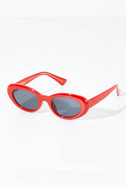 A model wearing size OneSize of the Siren Cats Eye Sunglasses in colour Red (Red), from the front, showing the whole outfit
