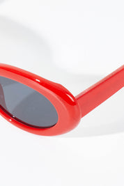 A model wearing size OneSize of the Siren Cats Eye Sunglasses in colour Red (Red), from the front, showing the whole outfit