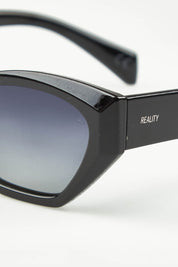 A model wearing the Wall Of Sound Sunglasses in colour Black (Black), from the front, showing the whole outfit