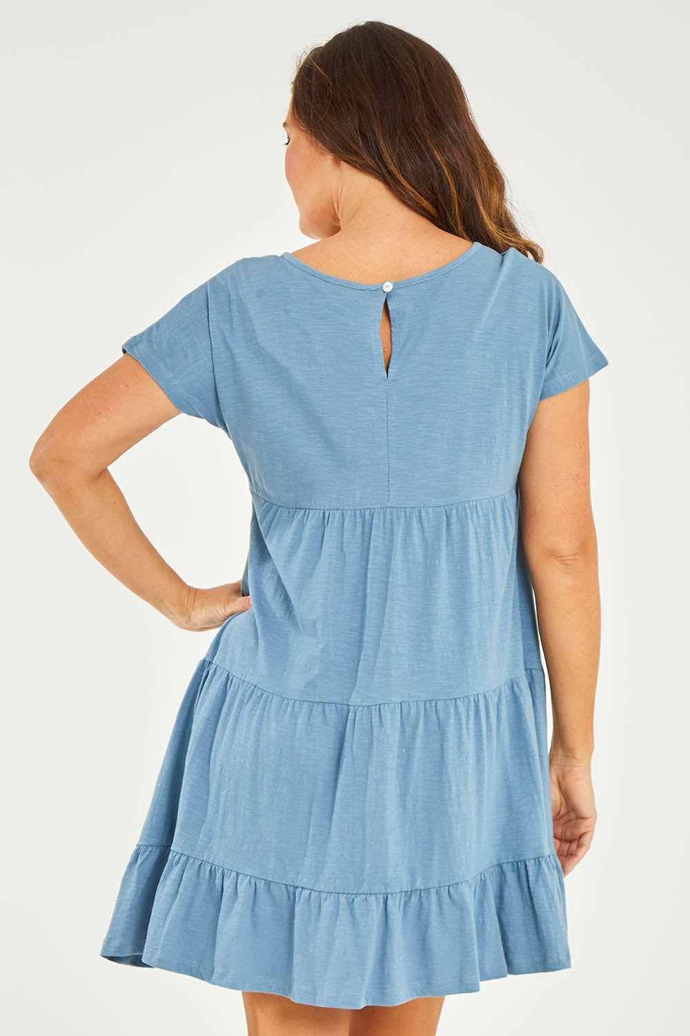 Model Georgia wearing size 10 of the Audrey Layered Dress in colour Denim (Blue), from the back