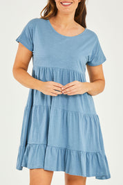Model Georgia wearing size 10 of the Audrey Layered Dress in colour Denim (Blue), from the front, cropped image