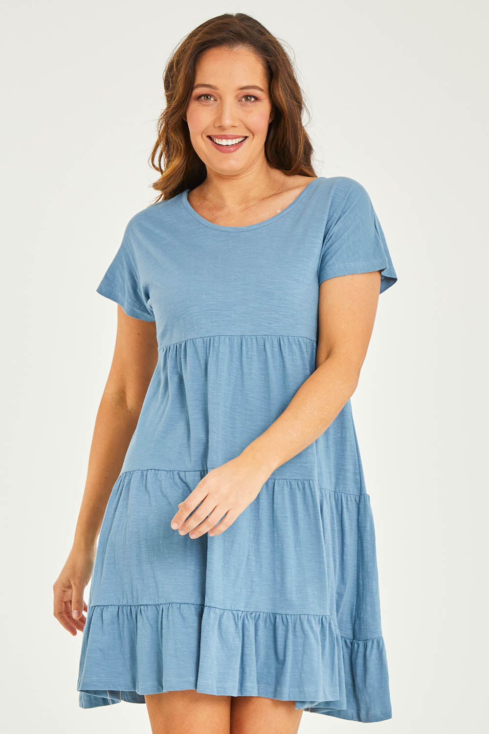 Model Georgia wearing size 10 of the Audrey Layered Dress in colour Denim (Blue), from the front, cropped image