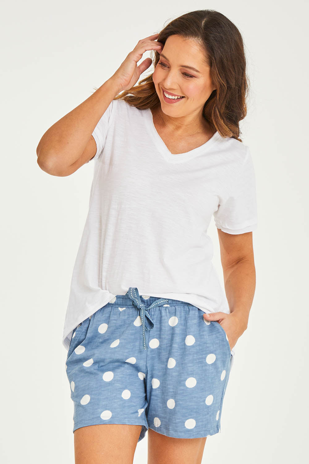 Model Georgia wearing size 10 of the Ava Cuff Short in colour Spotdenim (Blue), from the front, cropped image