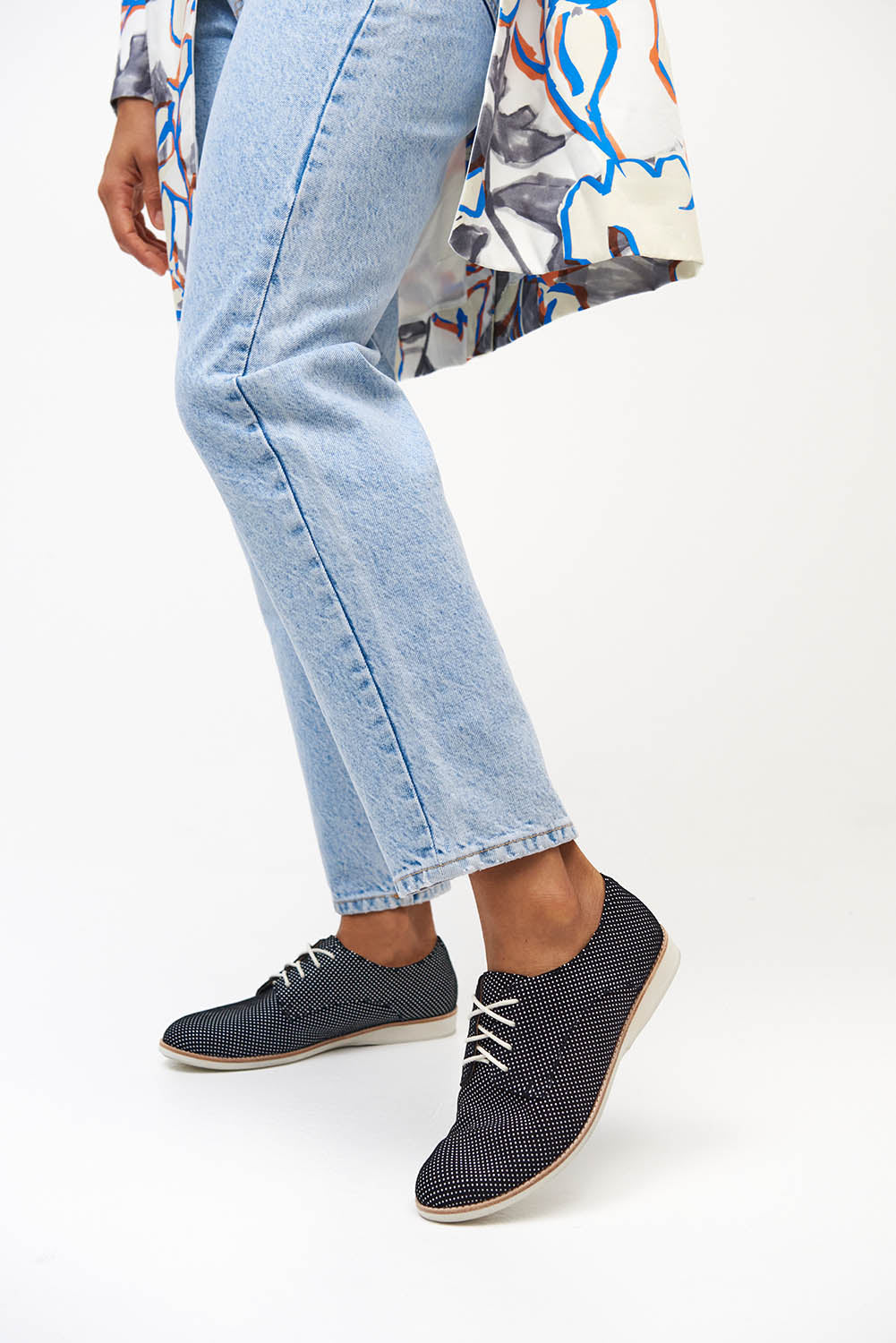 A model wearing the Derby Dream Flat in colour Blackspot (Black), from the front, cropped image