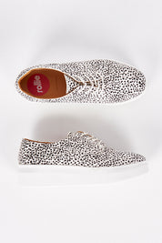 A model wearing size 37 of the Derby City Leather Flatform in colour Snowleopar (White), from the front, showing the whole outfit