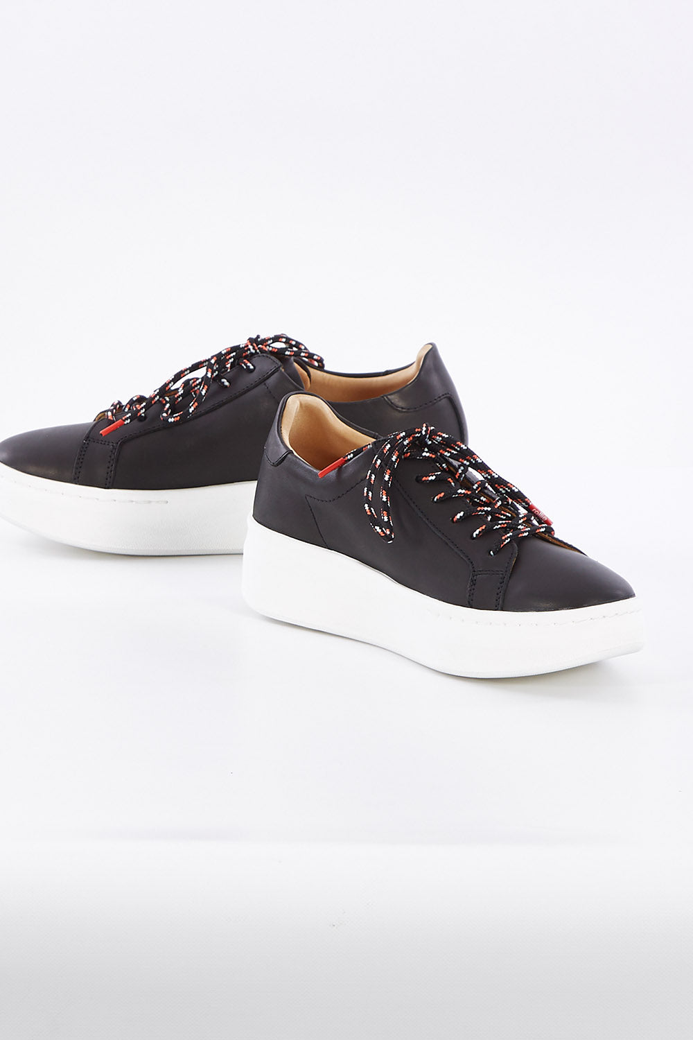 A model wearing size 37 of the City Sneaker in colour Black (Black), from the front, showing the whole outfit