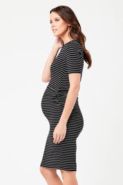 A model wearing the Mia Short Sleeve Nursing Maternity Dress in colour Blackflint (Black), from the front, cropped image
