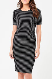 A model wearing the Mia Short Sleeve Nursing Maternity Dress in colour Blackflint (Black), from the front, cropped image