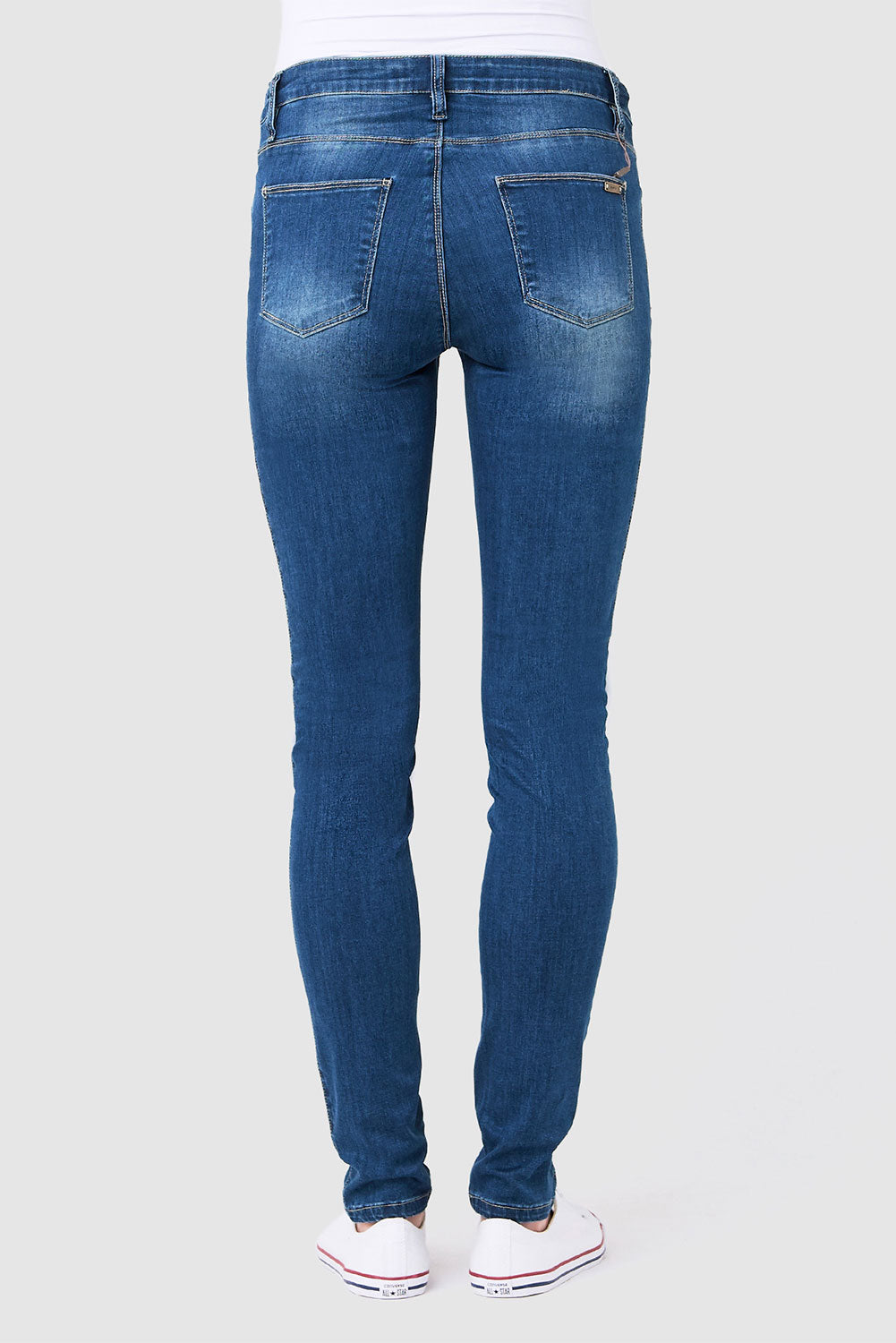 A model wearing the Isla Maternity Jegging in colour WashBack (Blue), from the back