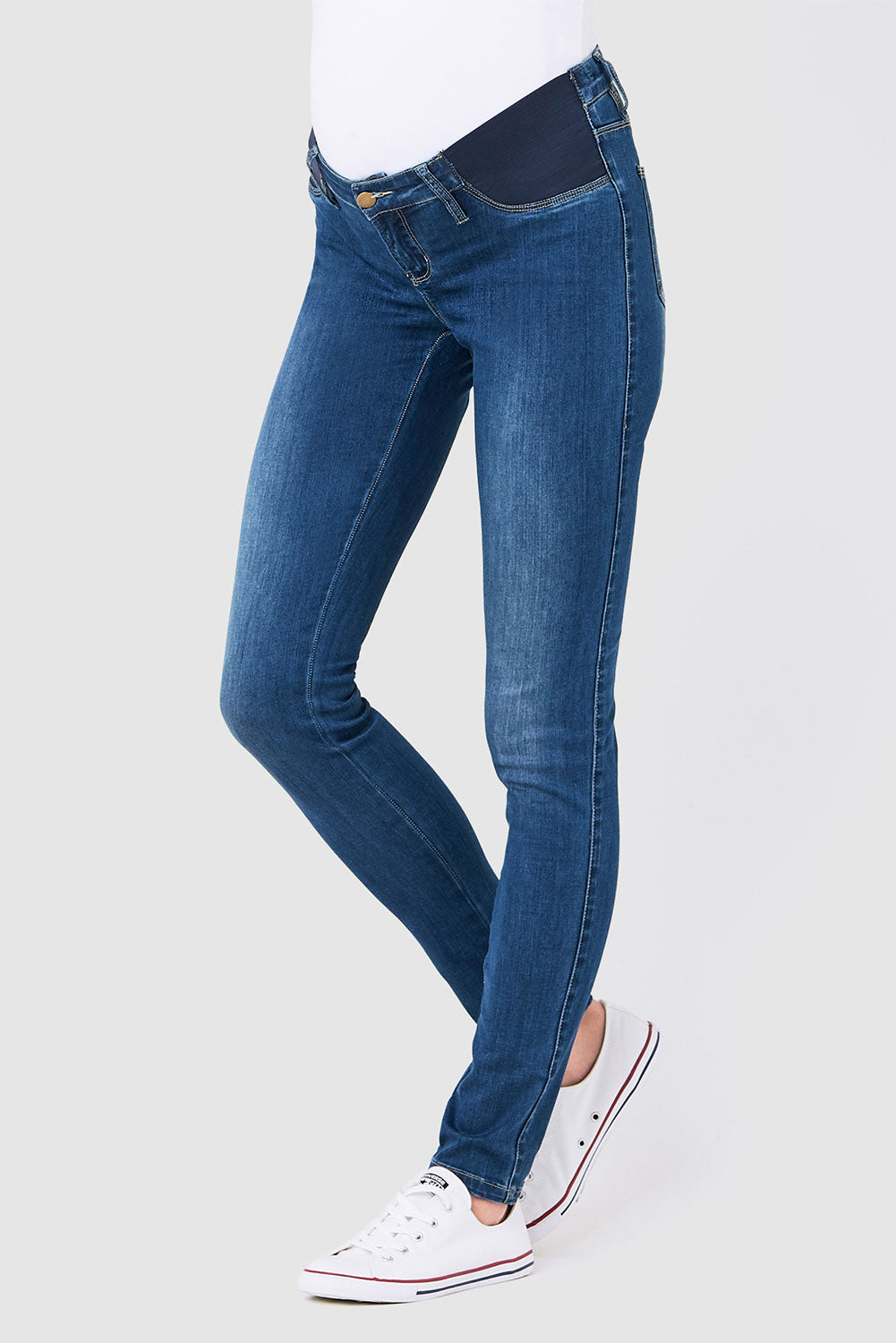A model wearing the Isla Maternity Jegging in colour WashBack (Blue), from the front, cropped image