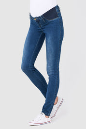A model wearing the Isla Maternity Jegging in colour WashBack (Blue), from the front, cropped image