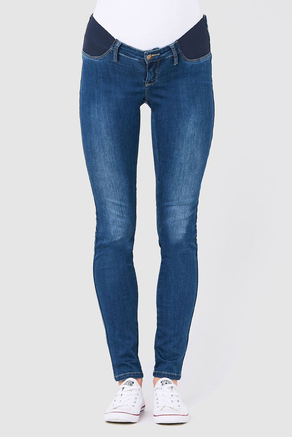 A model wearing the Isla Maternity Jegging in colour WashBack (Blue), from the front, cropped image
