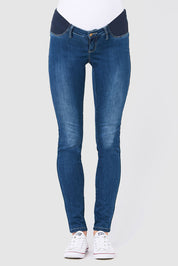 A model wearing the Isla Maternity Jegging in colour WashBack (Blue), from the front, cropped image