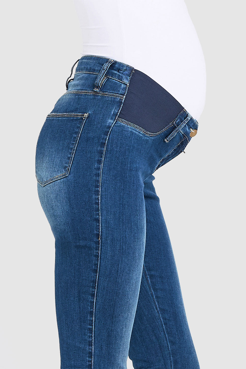 A model wearing the Isla Maternity Jegging in colour WashBack (Blue), from the front, cropped image