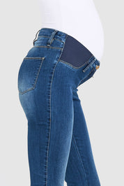 A model wearing the Isla Maternity Jegging in colour WashBack (Blue), from the front, cropped image