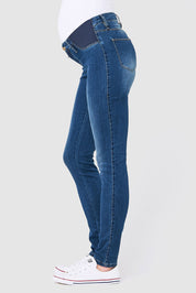 A model wearing the Isla Maternity Jegging in colour WashBack (Blue)