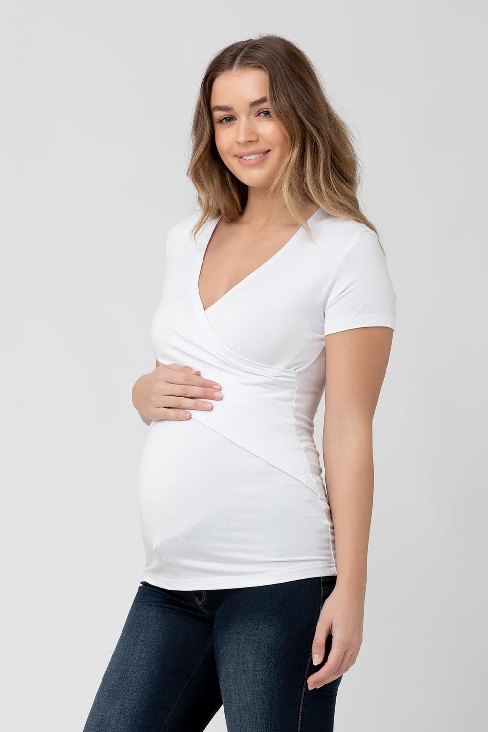 A model wearing the Embrace Tee in colour White (White), from the front, cropped image