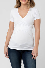 A model wearing the Embrace Tee in colour White (White), from the front, cropped image