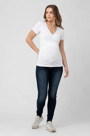 A model wearing the Embrace Tee in colour White (White), from the front, showing the whole outfit