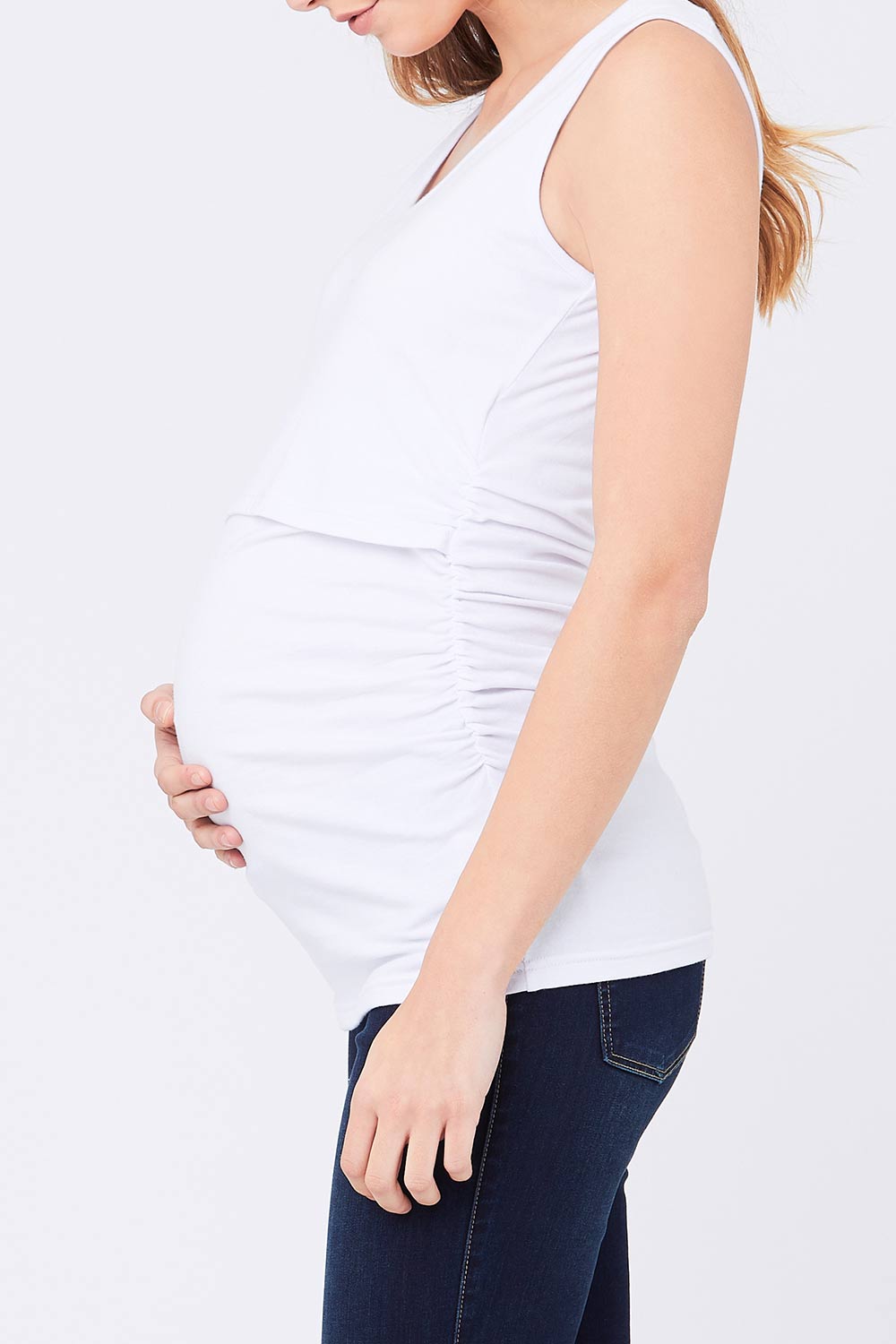 A model wearing the Ali Up Down Nursing Maternity Tank in colour White (White), from the front, cropped image