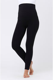 A model wearing the Over Tummy Maternity Legging in colour Black (Black), from the front, cropped image