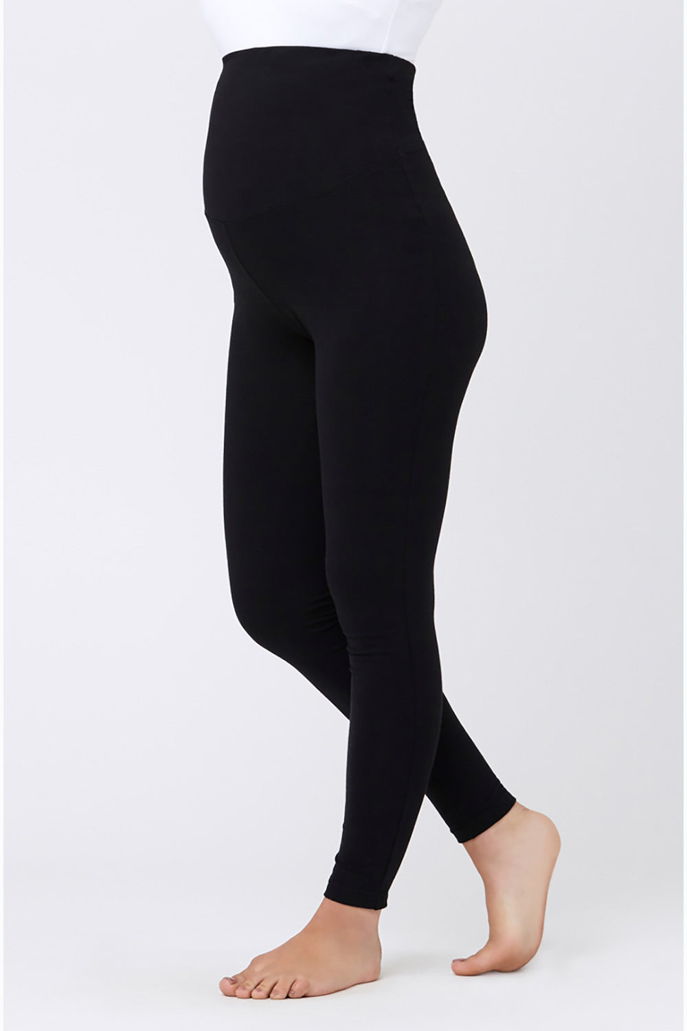 A model wearing the Over Tummy Maternity Legging in colour Black (Black), from the front, cropped image