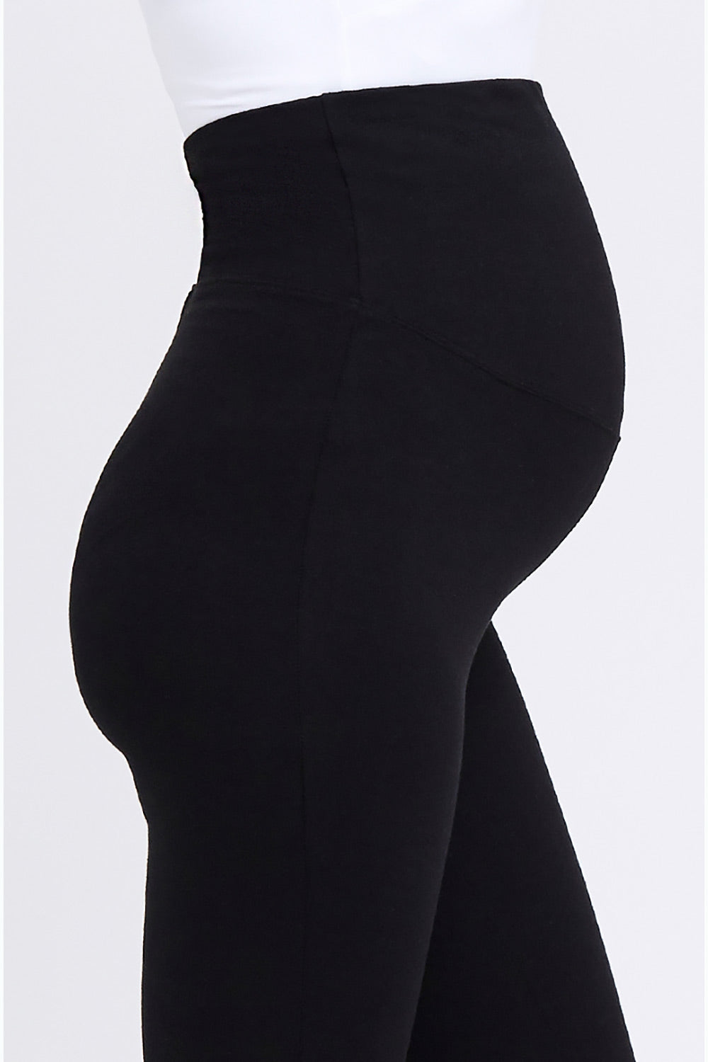 A model wearing the Over Tummy Maternity Legging in colour Black (Black), from the front, cropped image