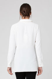 A model wearing the Tina Peplum Shirt in colour White (White), from the back