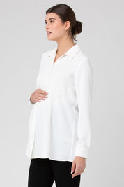 A model wearing the Tina Peplum Shirt in colour White (White), from the front, cropped image