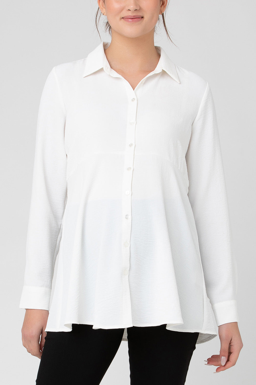 A model wearing the Tina Peplum Shirt in colour White (White), from the front, cropped image