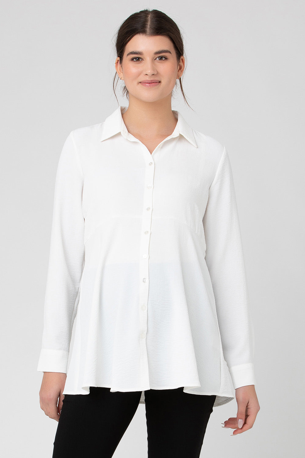 A model wearing the Tina Peplum Shirt in colour White (White), from the front, cropped image