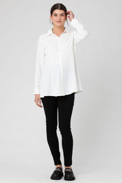A model wearing the Tina Peplum Shirt in colour White (White), from the front, showing the whole outfit