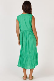 A model wearing the Andaman Cotton Midi Dress in colour Emerald (Green), from the back