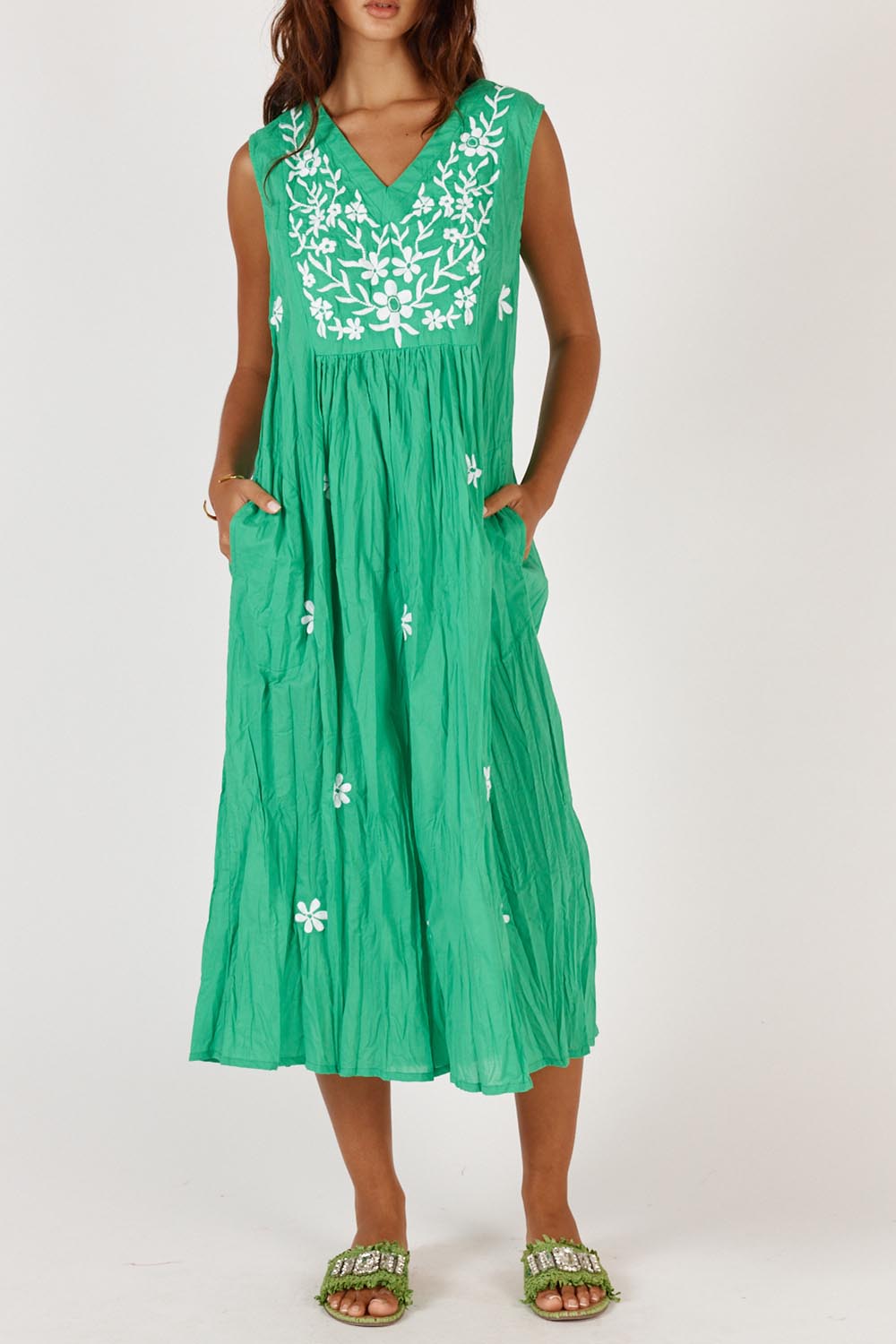A model wearing the Andaman Cotton Midi Dress in colour Emerald (Green), from the front, cropped image