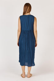 A model wearing the Andaman Cotton Midi Dress in colour Navy (Blue), from the back