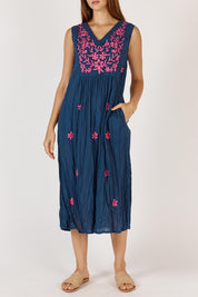 A model wearing the Andaman Cotton Midi Dress in colour Navy (Blue), from the front, cropped image