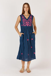 A model wearing the Andaman Cotton Midi Dress in colour Navy (Blue), from the front, showing the whole outfit