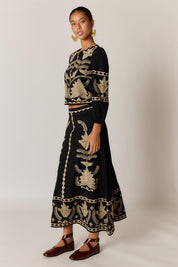 Model Genericm wearing size sample of the Arnun Skirt – Black in colour Black, from the front