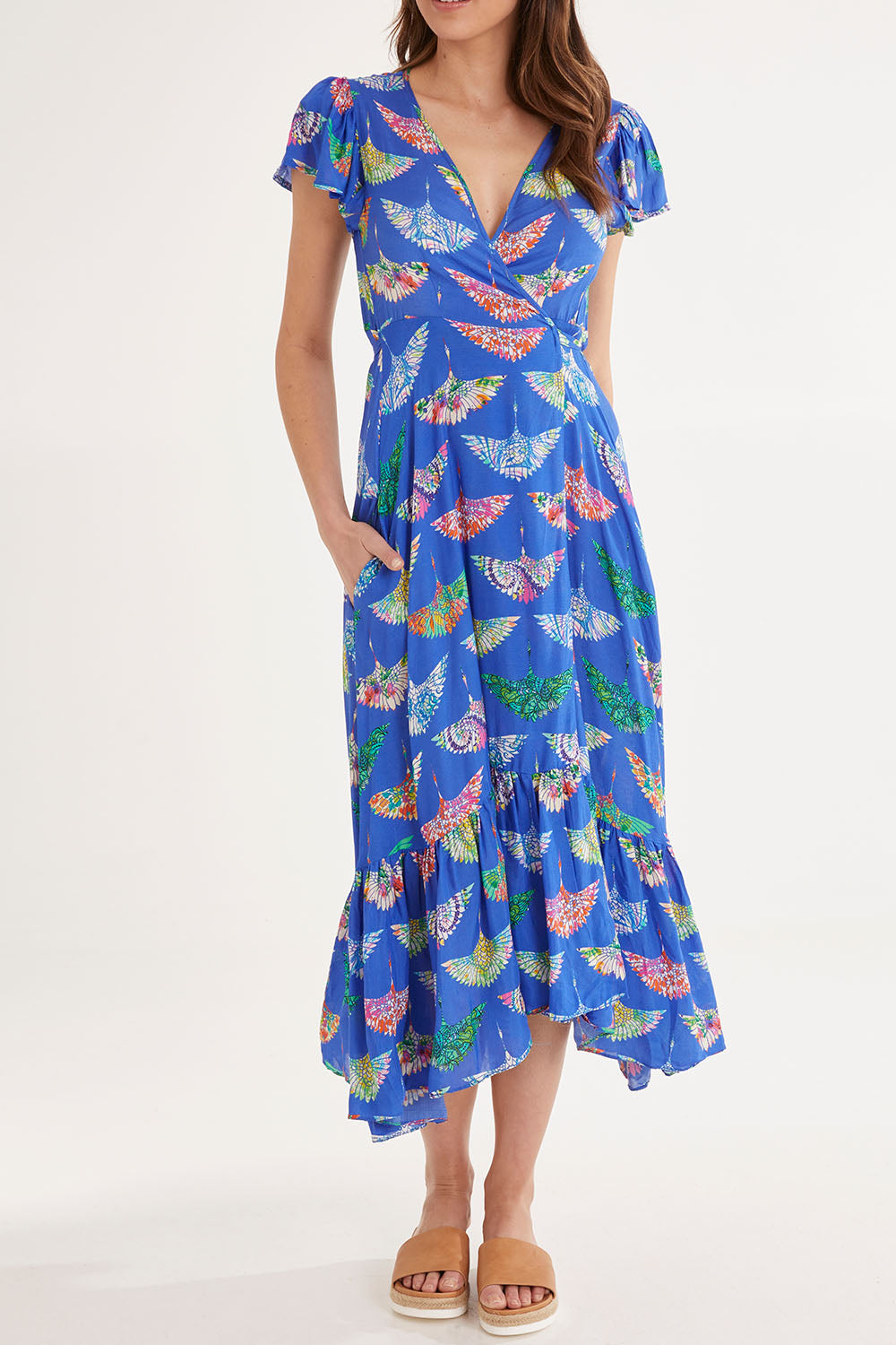 Model Madeline wearing size S of the Birds Of Surfers Wrap Dress in colour Blue (Blue), from the front, cropped image