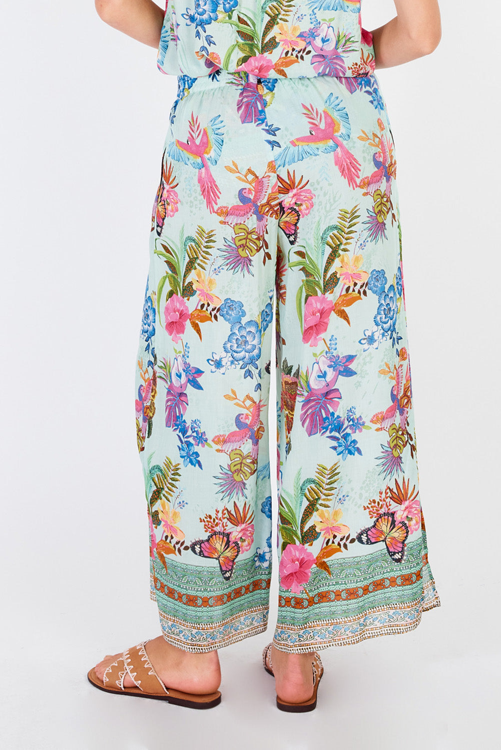A model wearing the Caatinga Pant in colour Mint (Green), from the back