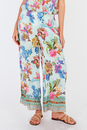 A model wearing the Caatinga Pant in colour Mint (Green), from the front, cropped image